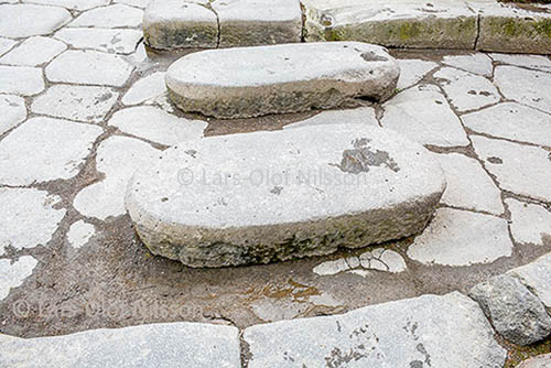 The image shows stepping stones in a street in Pompeii, Italy to illustrate how to improve writing skills